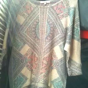 Its a multi color shirt, low cut sleeves, cotton